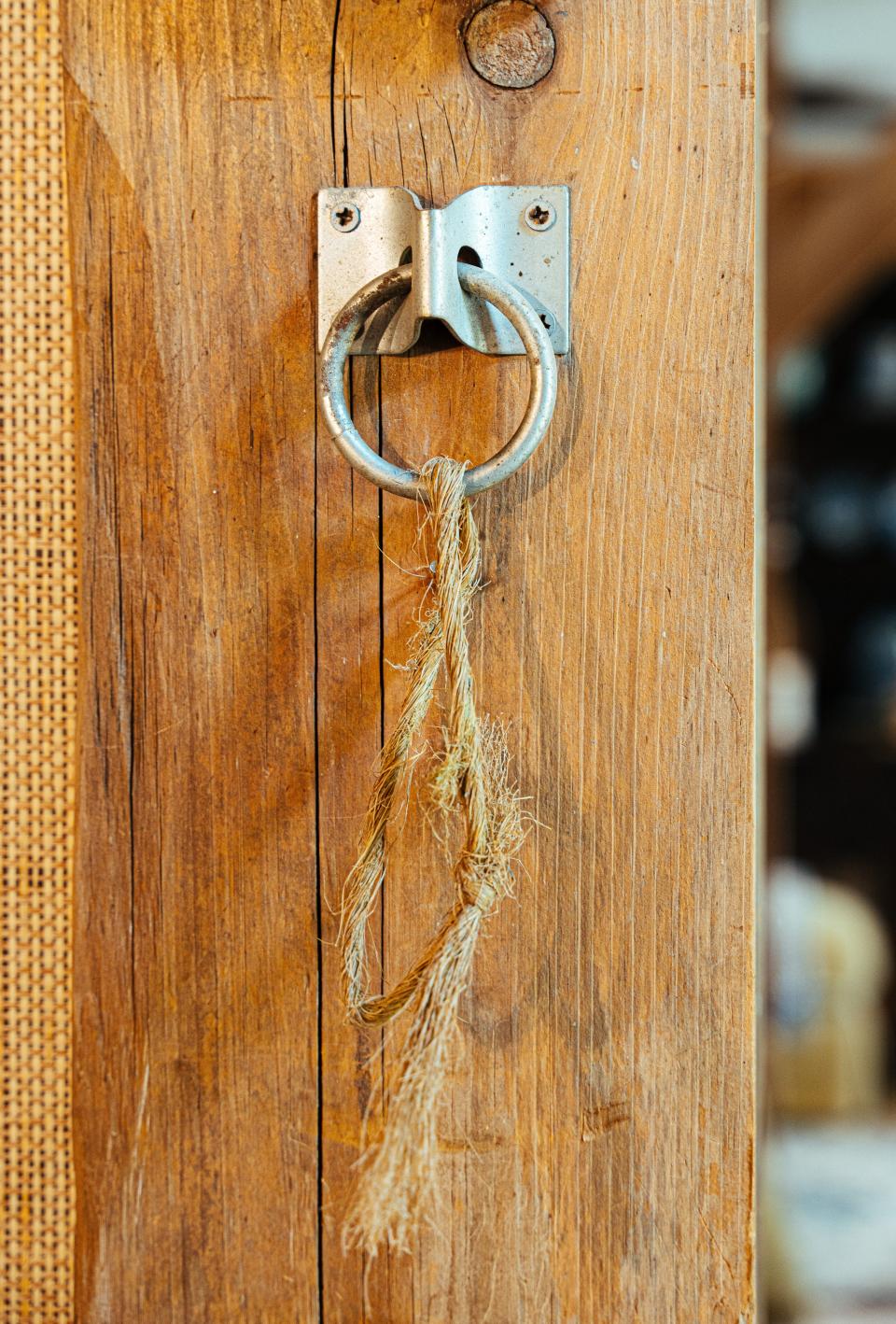 Original hitching post hardware and evidence of horses cribbing was left intact on interior wooden hand-hewn beams.