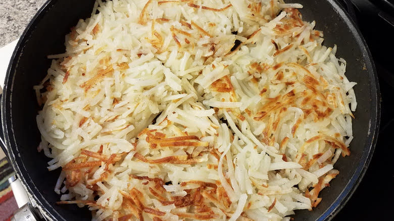 hash browns frying in skillet