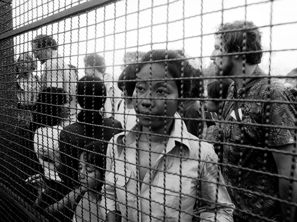 At the gate at the French Embassy in 1975, consular authorities are trying to accommodate the flux of people wanting to take refuge inside the embassy.