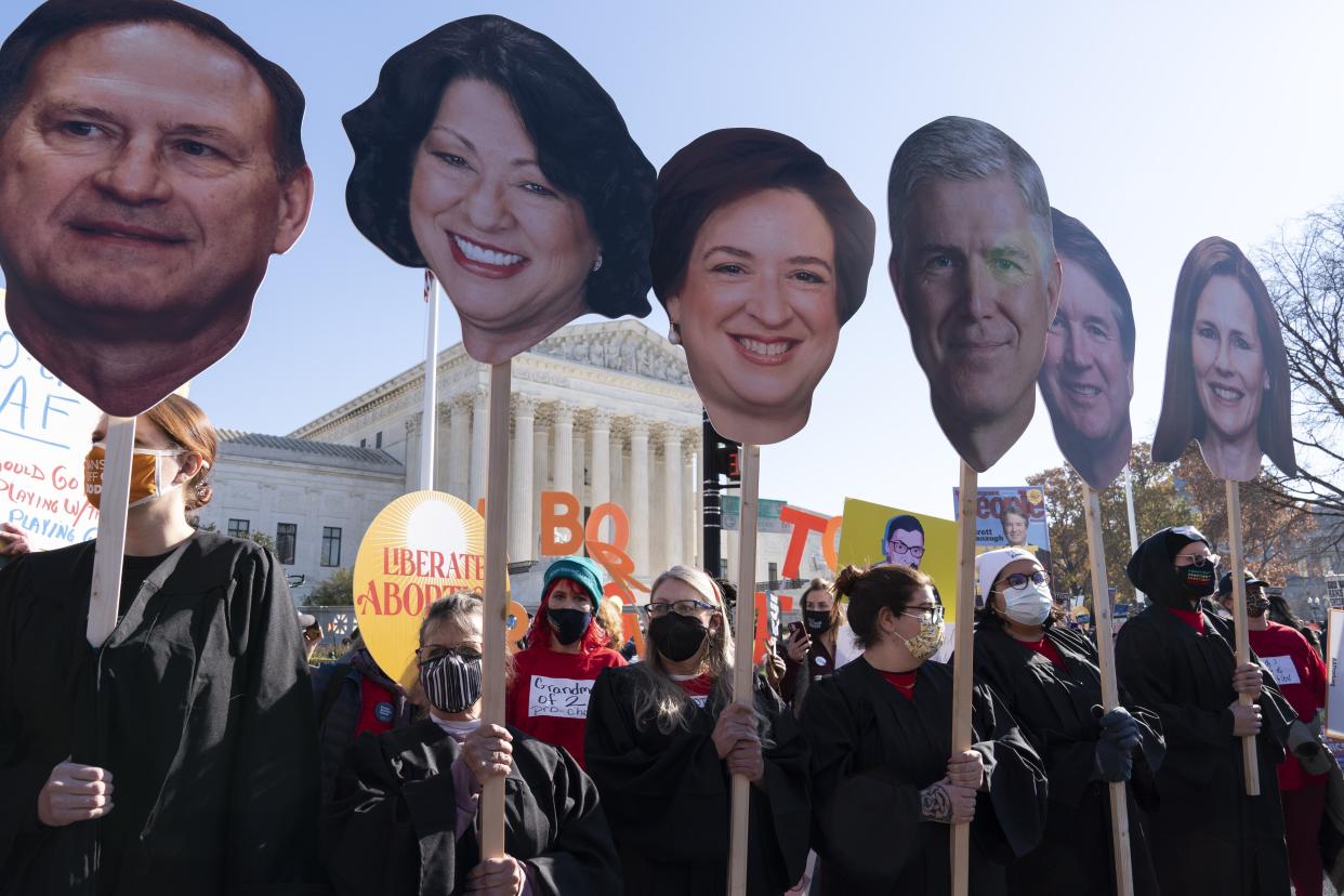 Abortion rights advocates holding cardboard cutouts of the Supreme Court justices demonstrate in front of the U.S. Supreme Court on Wednesday.