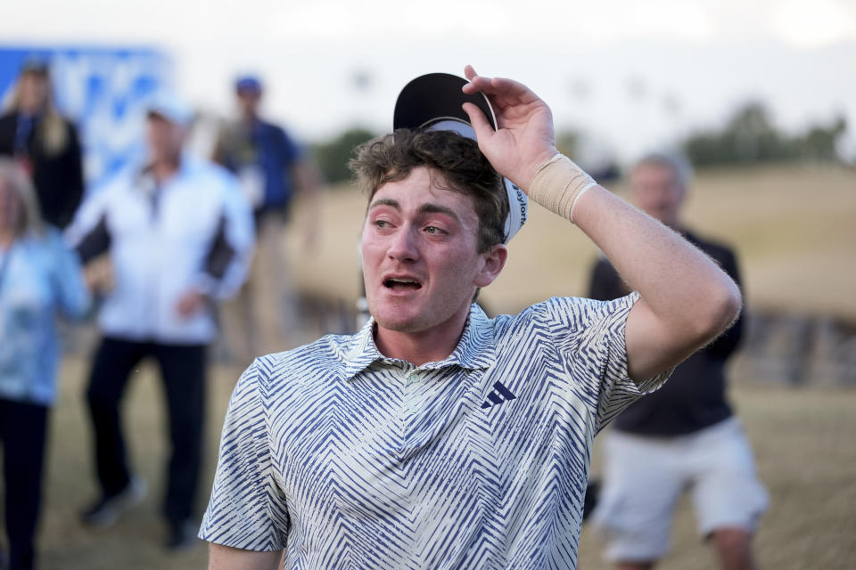 Nick Dunlap reacts after finishing on the 18th hole of the Pete Dye Stadium Course during the final round to win the American Express golf tournament, Sunday, Jan. 21, 2024, in La Quinta, Calif. (AP Photo/Ryan Sun)