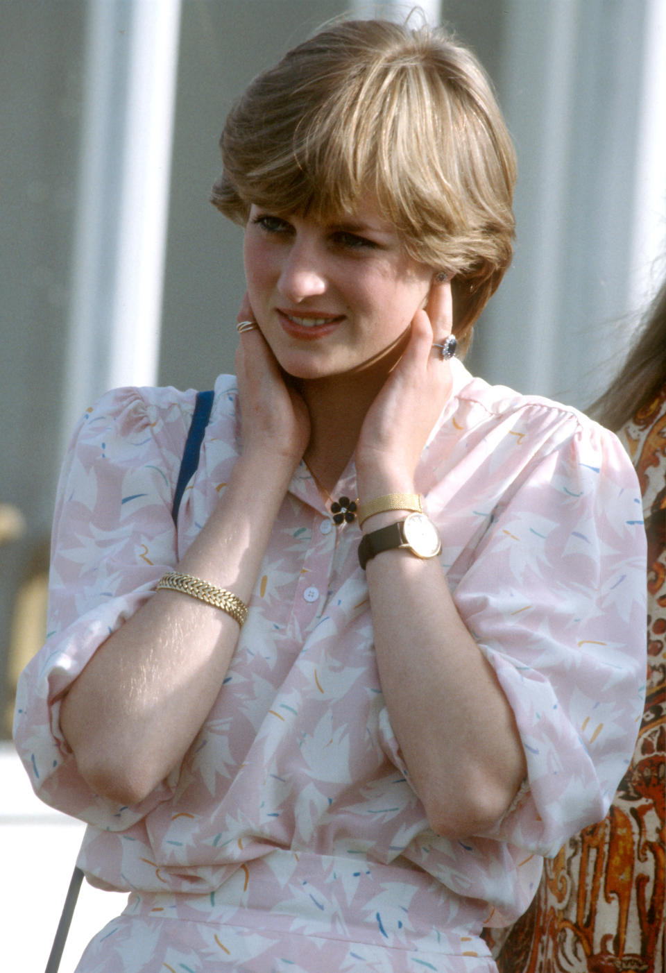 WINDSOR, ENGLAND - JULY 26: Lady Diana Spencer, wearing a pink patterned dress, two watches and a gold bracelet which were birthday presents from Prince Charles, attends the Cartier International polo match at Guards Polo Club, three days before her wedding to Prince Charles, Prince of Wales on July 26, 1981 in Windsor, United Kingdom. (Photo by Anwar Hussein/Getty Images)