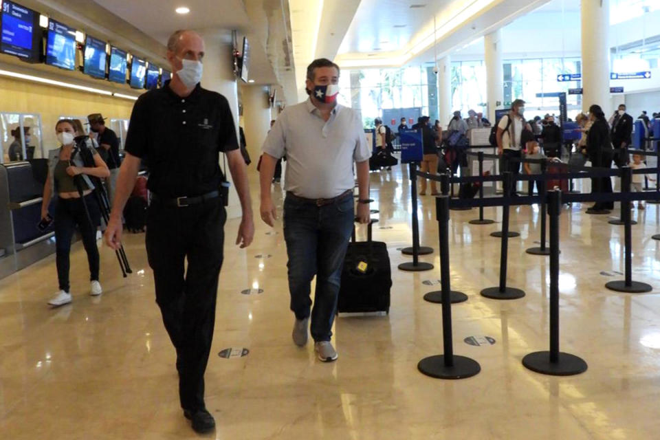 Ted Cruz checks in for a flight at Cancun International Airport. (Photo by MEGA/GC Images)