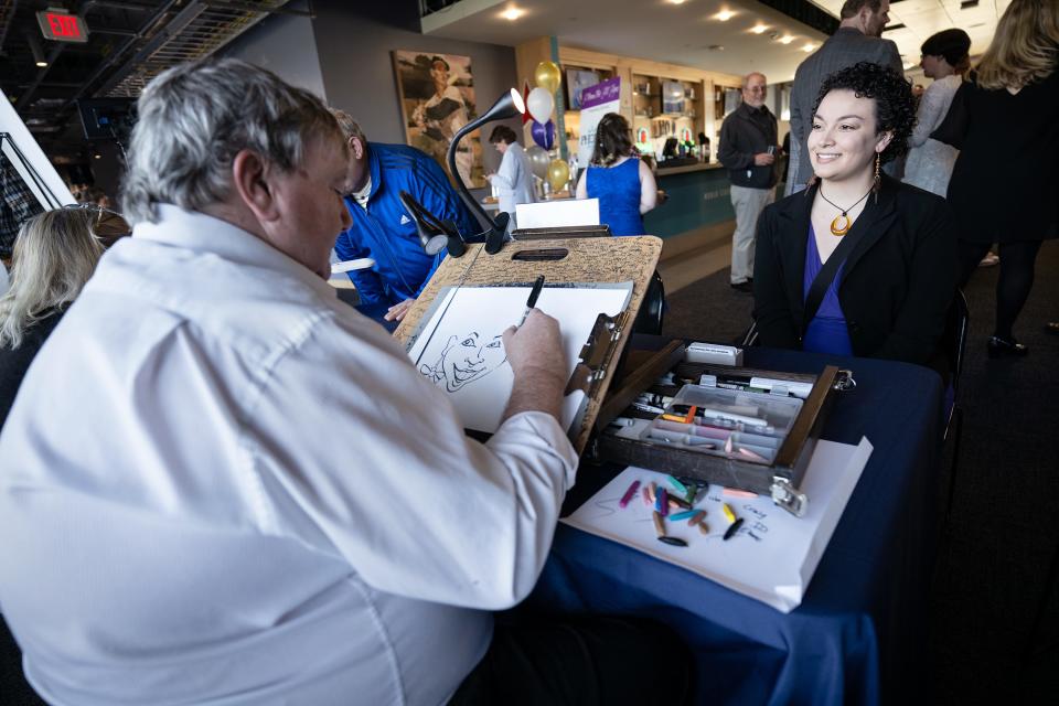 Amber Cannalonga poses for caricaturist Don Landgren during Thrive Support & Advocacy’s third annual Prom for All Ages Thursday at Polar Park.