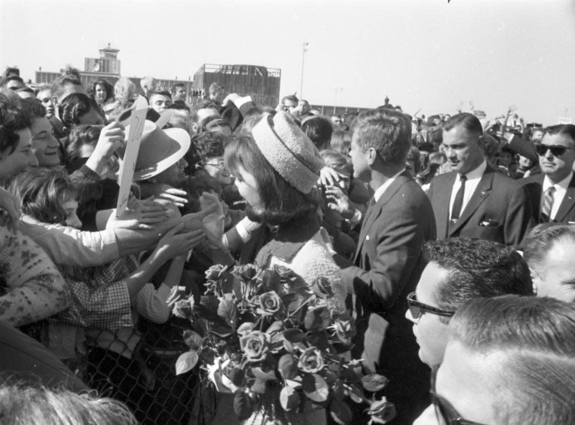 Nov. 22, 1963: President and Mrs. John F. Kennedy arrive at Love Field, Dallas, greeted by a crowd. Bodyguard to Mrs. Kennedy is Clint Hill.