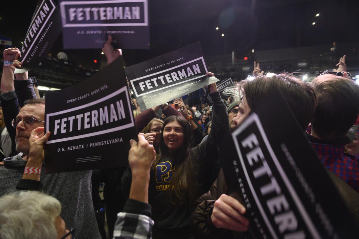 Fetterman supporters cheer at an election night event.
