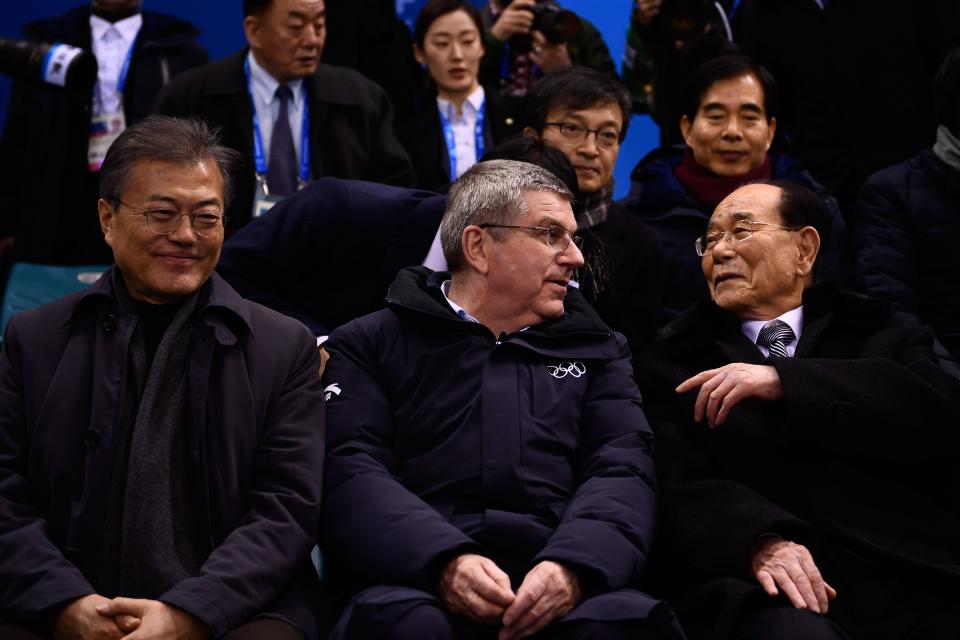 <p>North Korea’s ceremonial head of state Kim Yong Nam (R) speaks with President of the International Olympic Committee Thomas Bach and South Korea’s President Moon Jae-in (L) as they attend the the women’s preliminary round ice hockey match between Switzerland and the Unified Korean team. </p>