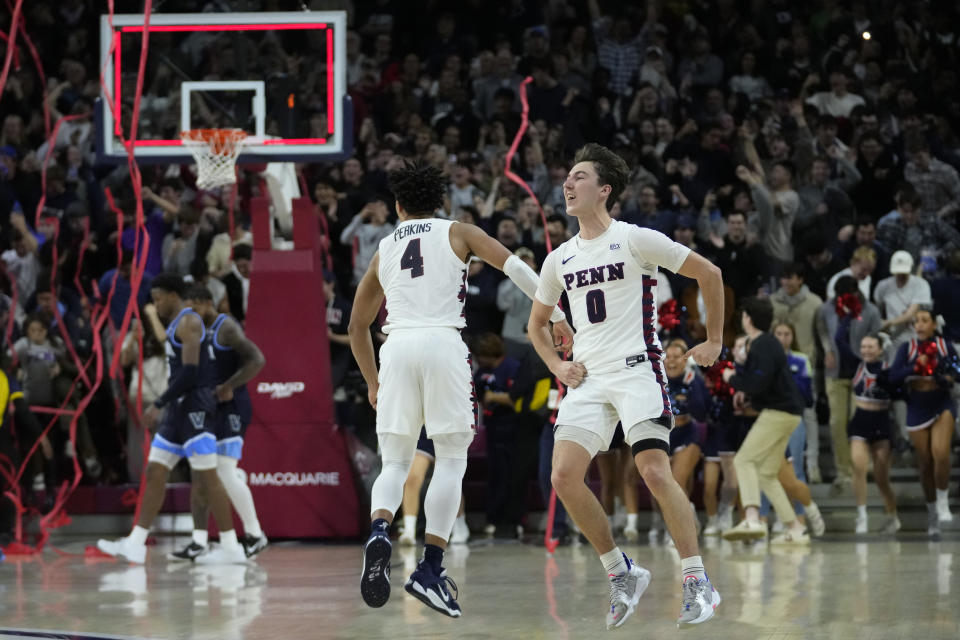 Pennsylvania's Clark Slajchert (0) and Tyler Perkins (4) celebrate after Pennsylvania won an NCAA college basketball game against Villanova, Monday, Nov. 13, 2023, in Philadelphia. (AP Photo/Matt Slocum)