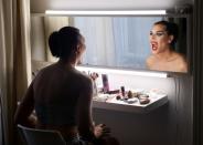 Transgender woman Tokodi gestures while putting on makeup at home in Budapest