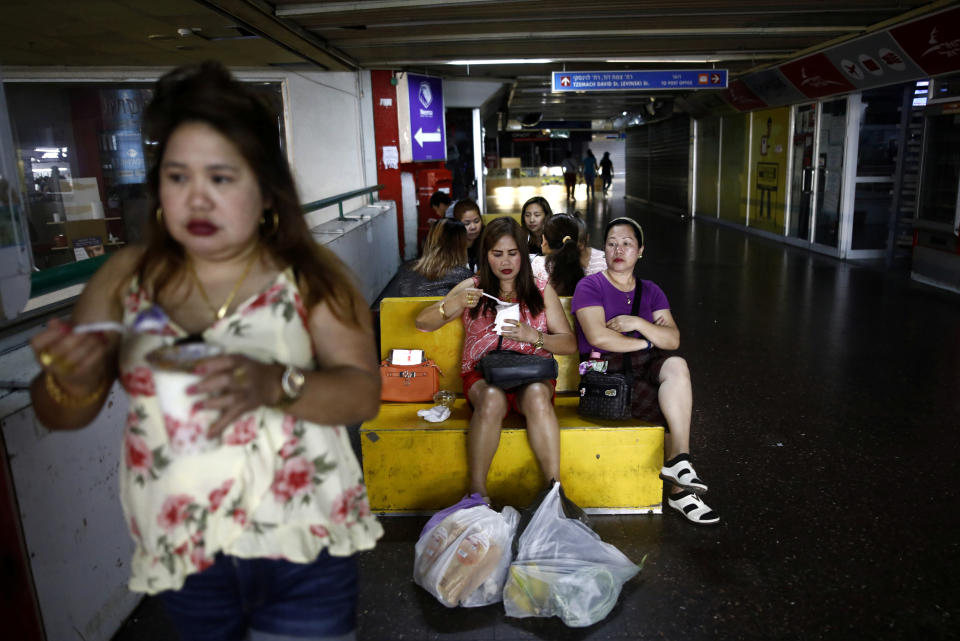 Food purchased from a Filipino food market being consumed inside the Central Bus Station on May 25. (Photo: Corinna Kern/Reuters)