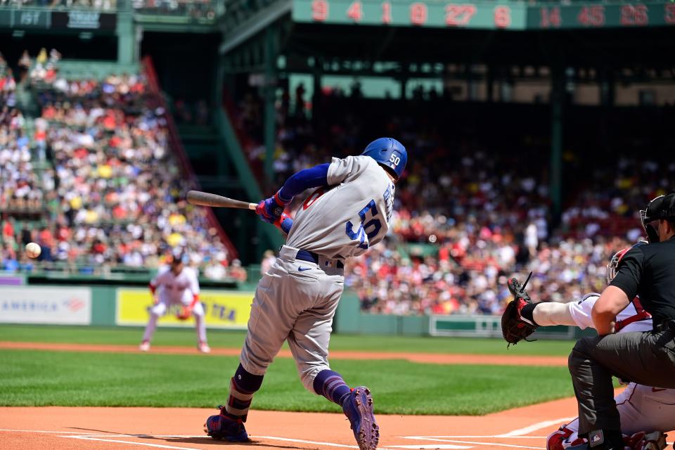 Dodgers second baseman Mookie Betts hits a single during the first inning on Sunday, part of a productive weekend at the plate against the Red Sox this weekend at Fenway Park.