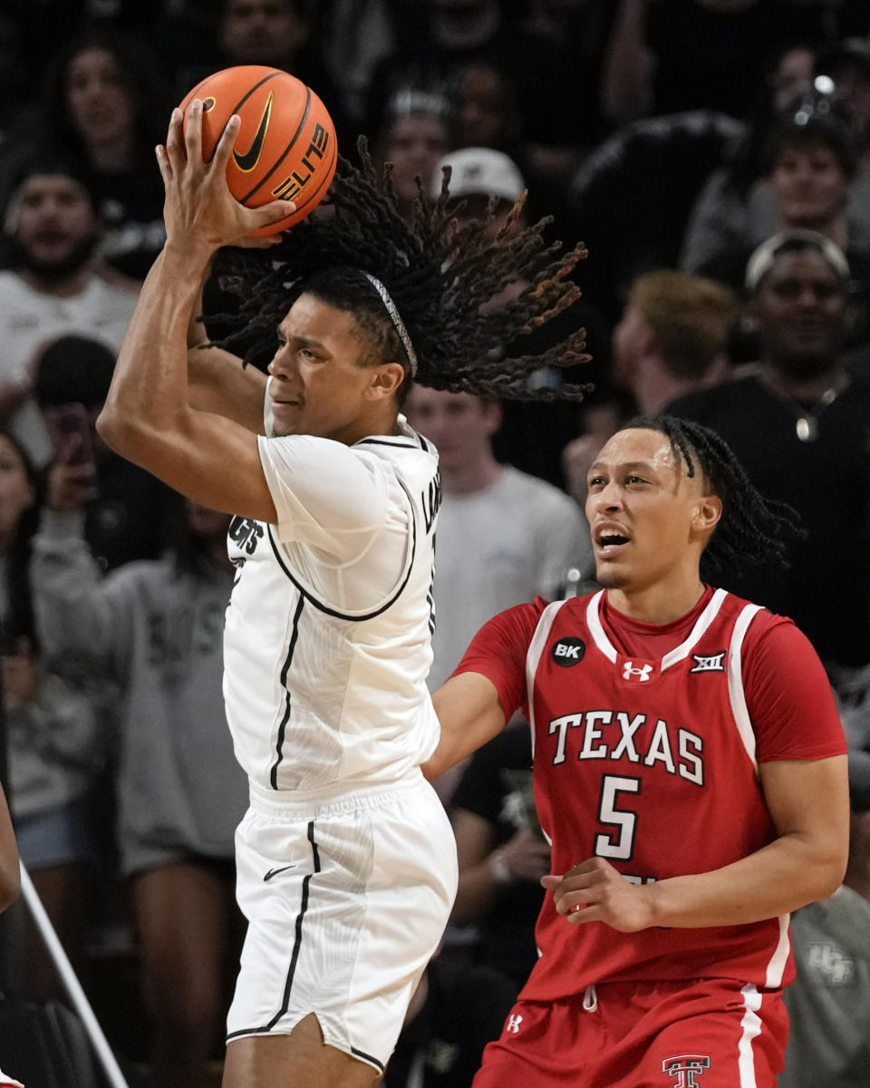 Central Florida guard DeMarr Langford Jr., left, grabs an offensive rebound in front of Texas Tech guard Darrion Williams (5) during the first half of an NCAA college basketball game, Saturday, Feb. 24, 2024, in Orlando, Fla. (AP Photo/John Raoux)