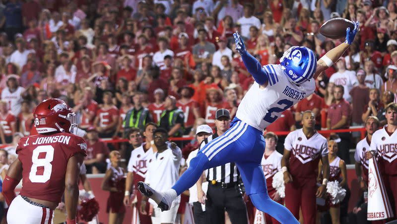 Brigham Young Cougars wide receiver Chase Roberts (2) makes a touchdown catch past Arkansas Razorbacks defensive back Jayden Johnson (8) at Razorback Stadium in Fayetteville on Saturday, Sept. 16, 2023. BYU won 38-31.