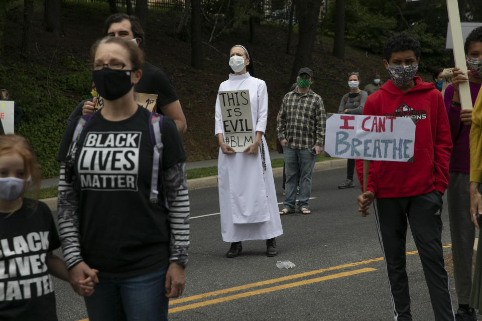 Sister Quincy Howard, center, a Dominican nun, protests the arrival Tuesday of President Donald Trump at the St. John Paul II National Shrine in Washington. (Photo: AP Photo/Jacquelyn Martin)