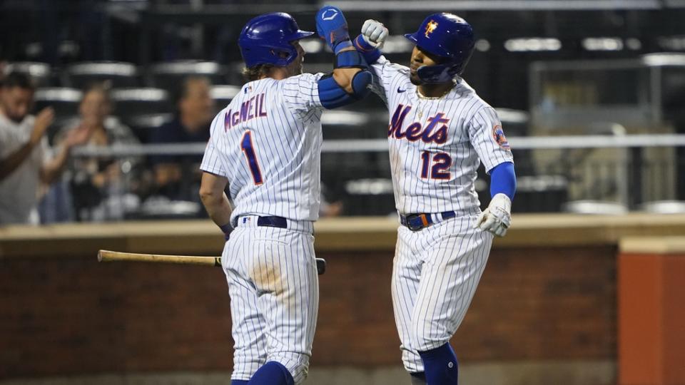 New York Mets shortstop Francisco Lindor (12) is congratulated by New York Mets second baseman Jeff McNeil (1) for hitting a home run against the Chicago Cubs during the ninth inning at Citi Field