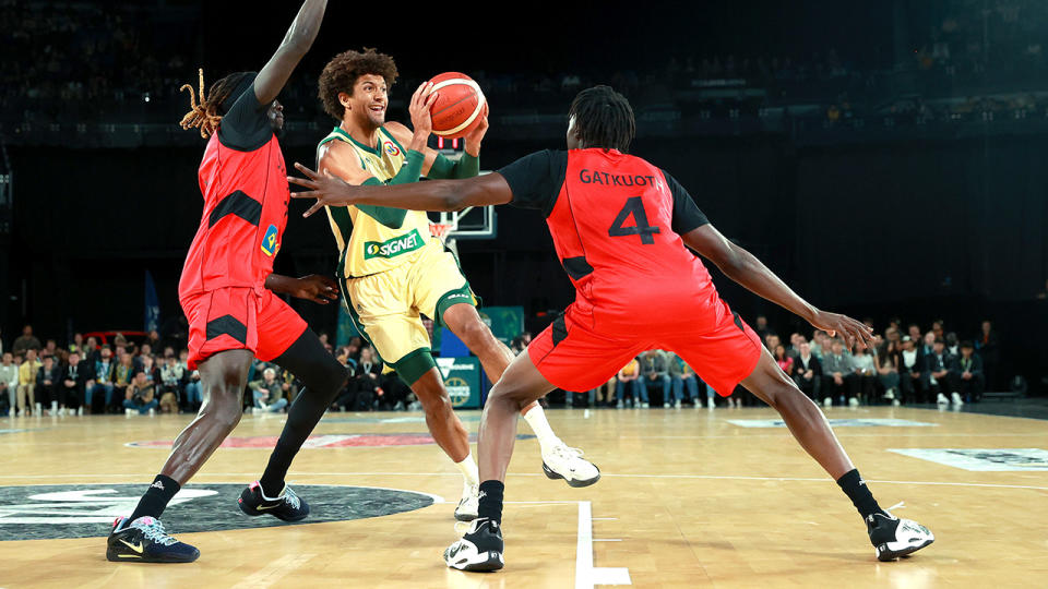 Matisse Thybulle drives the ball against the South Sudan defence.