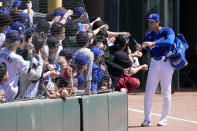 Los Angeles Dodgers' Shohei Ohtani, of Japan, signs autographs prior to a spring training baseball game against the Seattle Mariners, Wednesday, March 13, 2024, in Phoenix. (AP Photo/Ross D. Franklin)