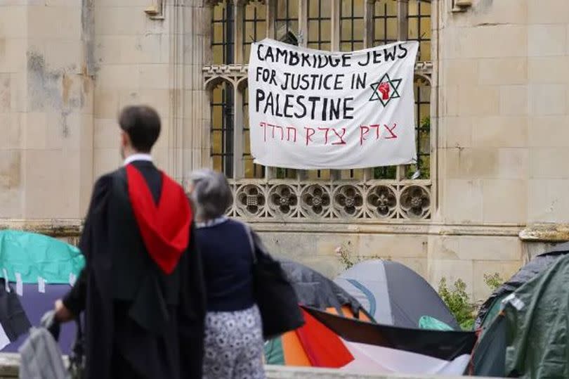 Student walking past Palestine sign