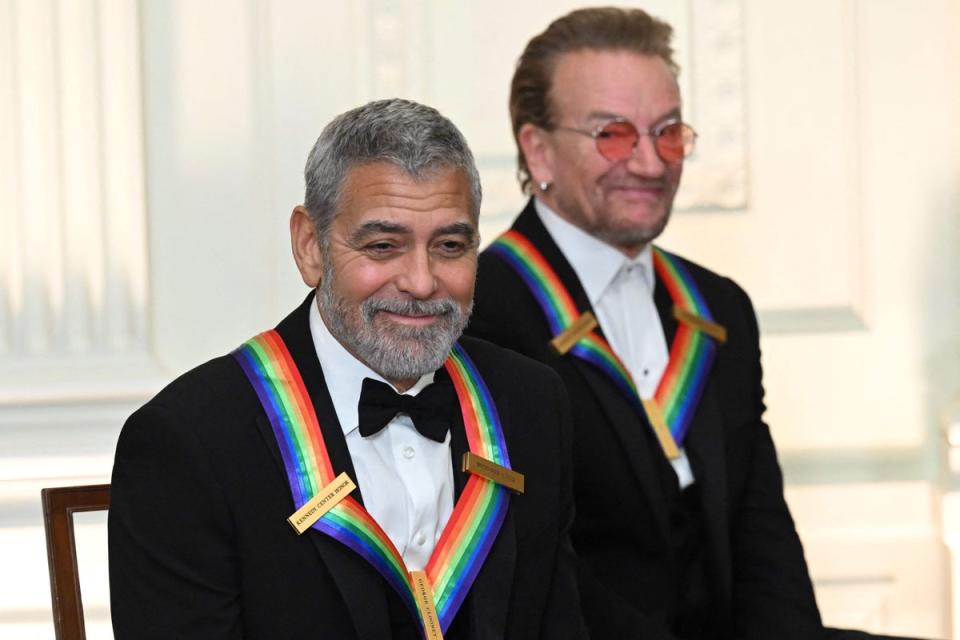 Kennedy Center honorees US actor George Clooney (L) and Bono of Irish band U2 attend a reception for the Kennedy Center Honorees in the East Room of the White House in Washington, DC, on December 4, 2022 (AFP via Getty Images)