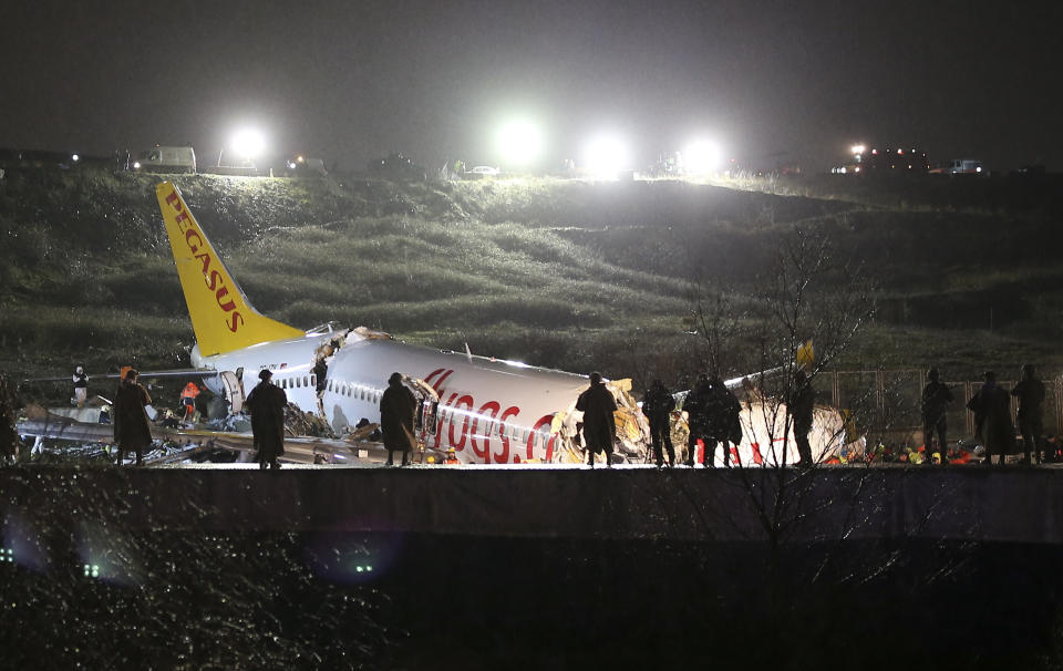 Rescue members and firefighters work at the scene after a plane skidded off the runway at Istanbul's Sabiha Gokcen Airport. Source: AP Photo/Emrah Gurel