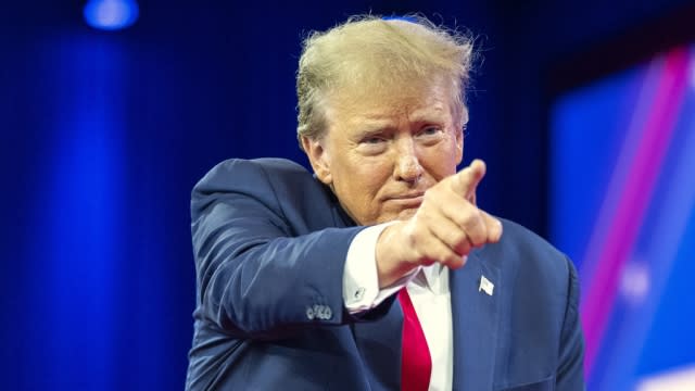 Republican presidential candidate former President Donald Trump points to a supporter as he departs after speaking.