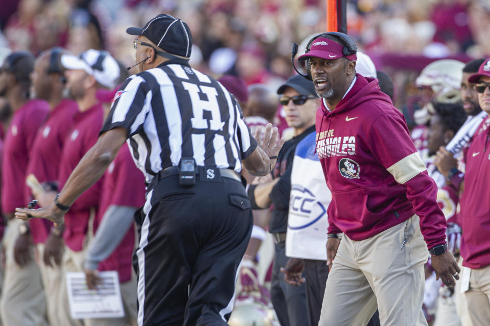 Florida State head coach Willie Taggart, right, disagrees with the referee in the first half of an NCAA college football game against Miami in Tallahassee, Fla., Saturday, Nov. 2, 2019. (AP Photo/Mark Wallheiser)