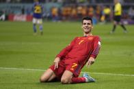 Spain's Alvaro Morata celebrates after scoring the opening goal of his team during the World Cup group E soccer match between Japan and Spain, at the Khalifa International Stadium in Doha, Qatar, Thursday, Dec. 1, 2022. (AP Photo/Darko Vojinovic)