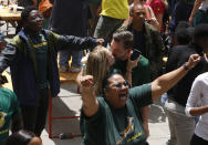 South Africa fans watching a giant screen at the Nelson Mandela Square in Johannesburg, South Africa, celebrate South Africa scoring points during the Rugby World Cup final between South Africa and England being played in Tokyo, Japan on Saturday Nov. 2, 2019. South Africa defeated England 32-12. (AP Photo/Denis Farrell)