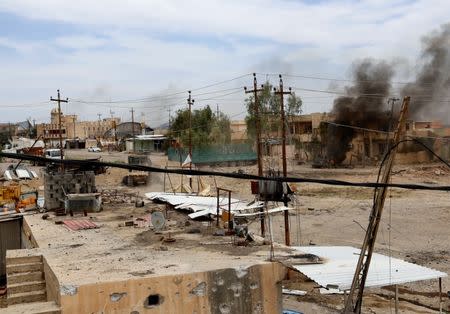 Smoke is seen after a suicide car bomb exploded during clashes between Iraqi forces and Islamic State militants in western Mosul, Iraq, May 16, 2017. REUTERS/Danish Siddiqui