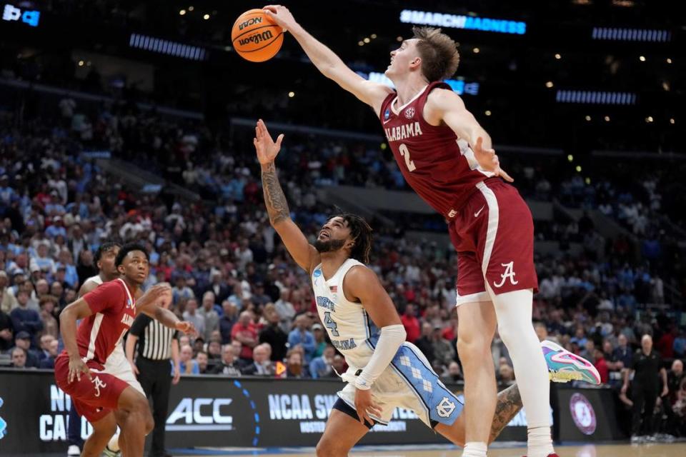 Mar 28, 2024; Los Angeles, CA, USA; Alabama Crimson Tide forward Grant Nelson (2) blocks North Carolina Tar Heels guard RJ Davis (4) in the second half in the semifinals of the West Regional of the 2024 NCAA Tournament at Crypto.com Arena. Kirby Lee/USA TODAY Sports