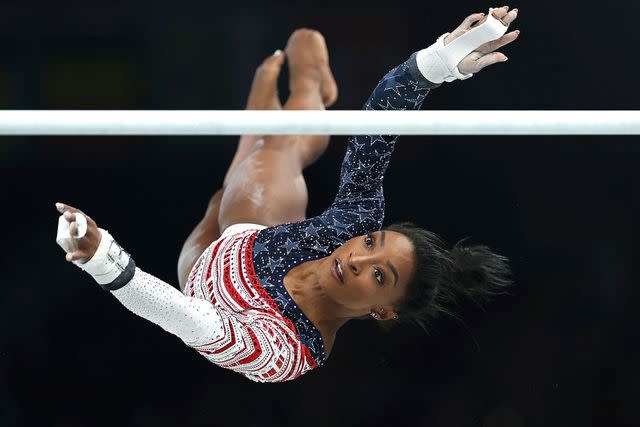 <p>Xinhua/Shutterstock</p> Simone Biles competes on the uneven bars at the Paris Olympics on July 30, 2024