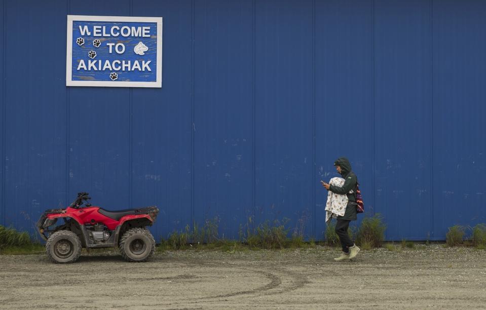 A villager arrives at the airport before boarding a flight, Friday, Aug. 18, 2023, in Akiachak, Alaska. Akiachak is a small village on the Kuskokwim River where boats and flights are most practical for travel outside the area. (AP Photo/Tom Brenner)