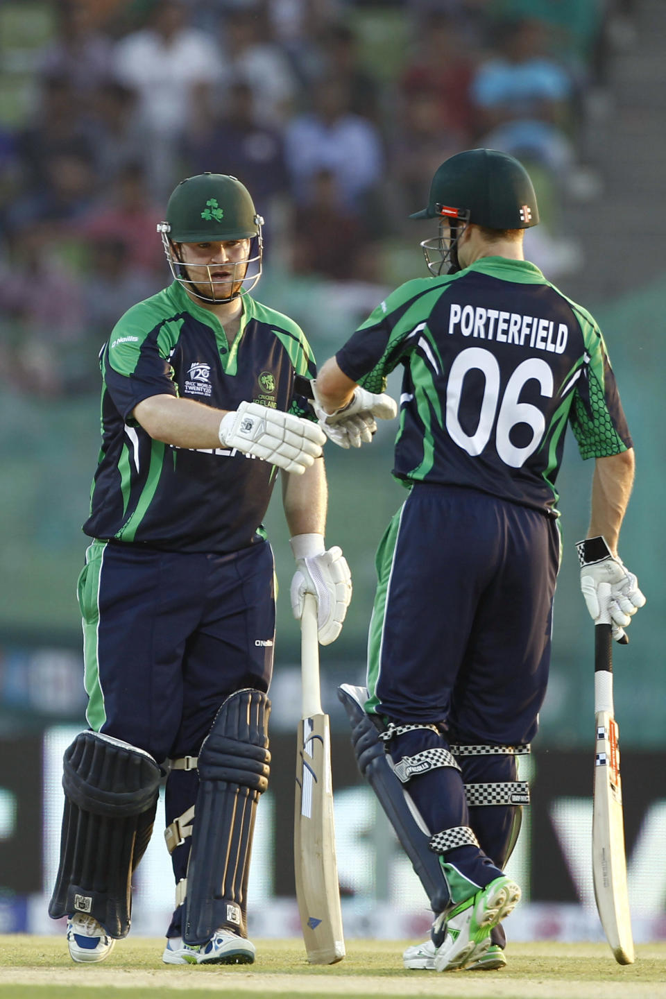 Ireland batsman Paul Stirling, left, celebrates with his captain William Porterfield after playing a boundary shot during their ICC Twenty20 Cricket World Cup match against Zimbabwe in Sylhet, Bangladesh, Monday, March 17, 2014. (AP Photo/A.M. Ahad)