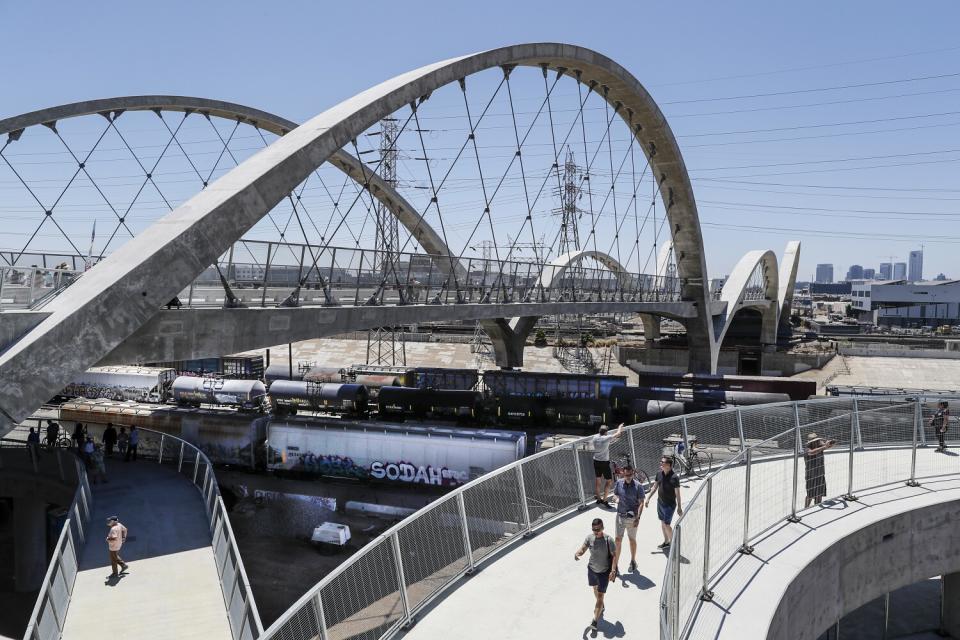 People walk along the 6th Street Viaduct.