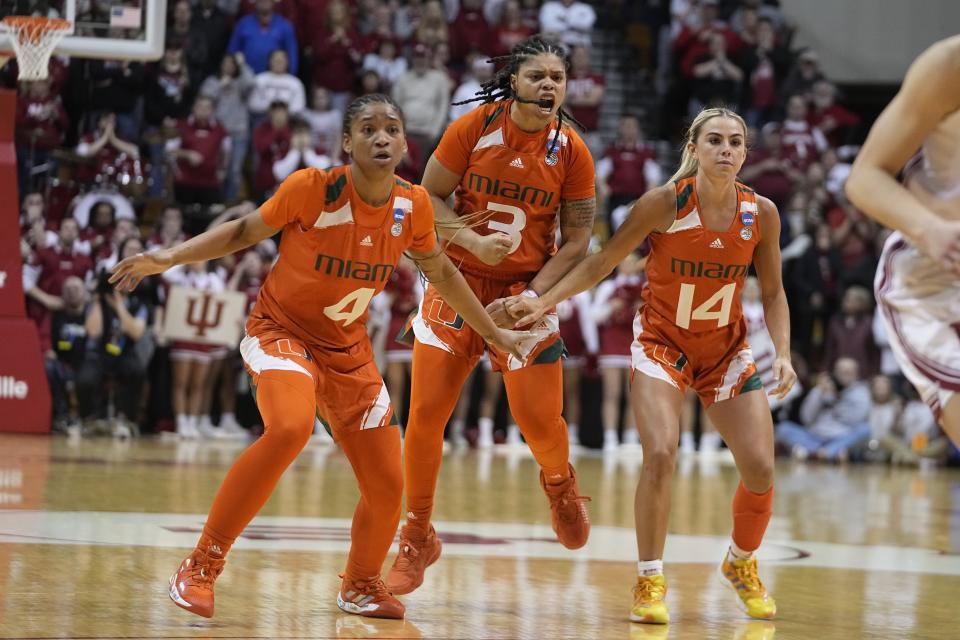 Miami's Jasmyne Roberts (4), Destiny Harden (3) and Haley Cavinder (14) react after Harden hit a shot late in the second half of a second-round college basketball game against Indiana in the women's NCAA Tournament Monday, March 20, 2023, in Bloomington, Ind. (AP Photo/Darron Cummings)