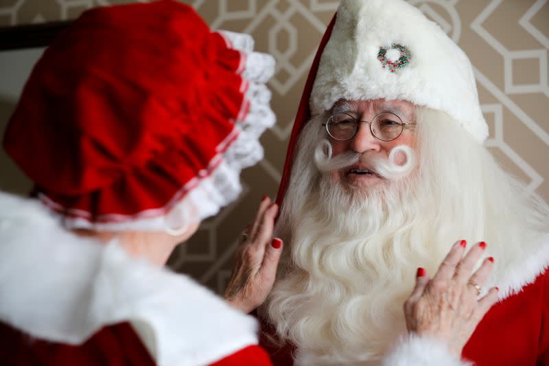 American couple Fred and Kathleen Honerkamp, chat in their Santa Claus outfits as they prepare to visit Jerusalem's Old City together with a group of Santa Clauses from around the world, at their hotel in Jerusalem