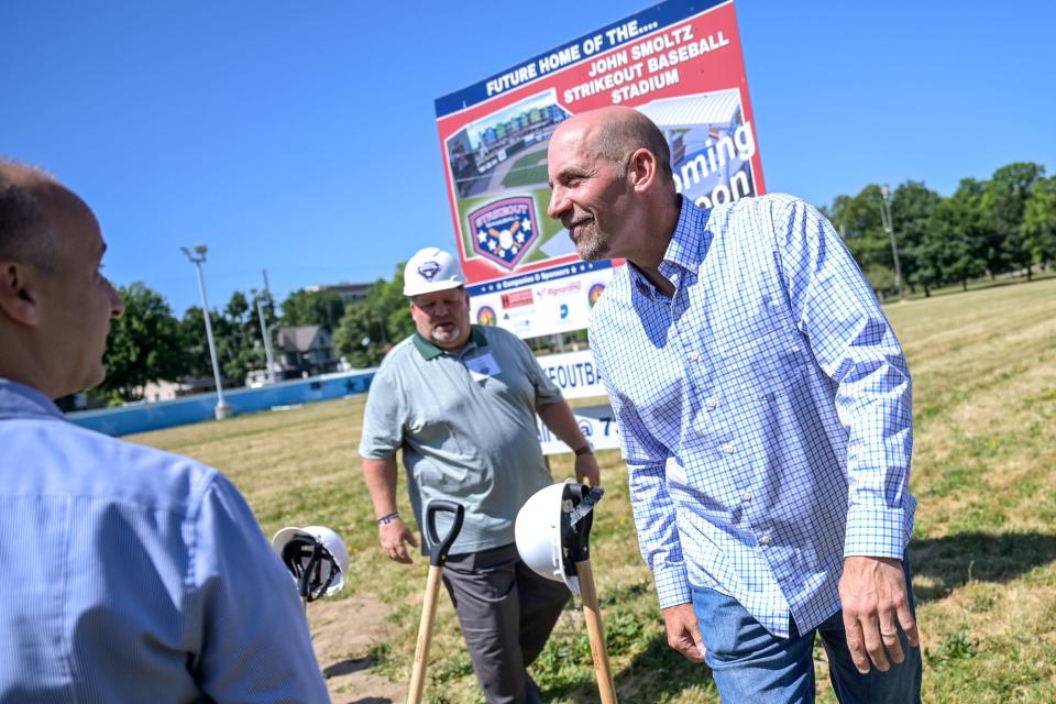MLB Hall of Famer and Lansing native John Smoltz, right, smiles after Mayor Andy Schor, left, founder Jeff Lazaros, center, and other officials shoveled dirt during a groundbreaking ceremony for the John Smoltz Strikeout Baseball Stadium on Tuesday, June 28, 2022, at Ferris Park in Lansing.