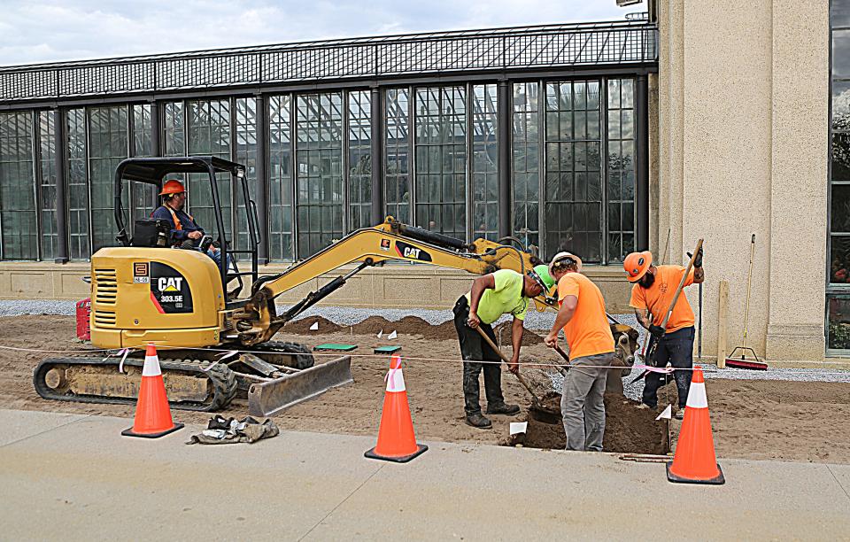 Workers at Longwood Gardens lay fresh soil for the new sod that will be laid down as part of a renovation project called "Longwood Reimagined".