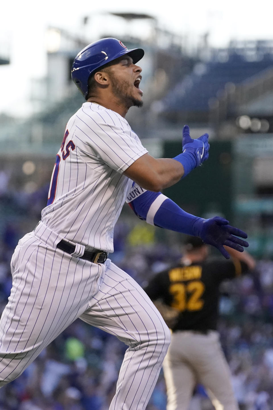 Chicago Cubs' Willson Contreras celebrates his grand slam off Pittsburgh Pirates relief pitcher Bryse Wilson, background, during the first inning of a baseball game Monday, May 16, 2022, in Chicago. (AP Photo/Charles Rex Arbogast)