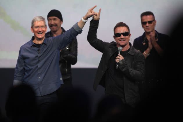 Apple CEO Tim Cook connects fingers with Bono to symbolically launch the release of U2's new album on Apple's iTunes during an Apple product release event at the Flint Center in Cupertino, Calif., on Tuesday, Sept. 9, 2014.  (Karl Mondon/Bay Area News Gro - Credit: MediaNews Group via Getty Images