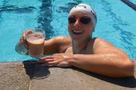 <p>Olympic gold medalist Katie Ledecky swims the length of a pool while balancing a glass of chocolate milk on her head for the #gotmilkchallenge on TikTok on Monday. </p>