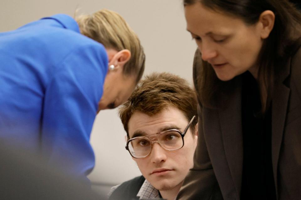 Marjory Stoneman Douglas High School shooter Nikolas Cruz is shown at the defense table as Assistant Public Defender Melisa McNeill, left, and sentence mitigation specialist Kate O'Shea, a member of the defense team, speak during the penalty phase of the trial of Marjory Stoneman Douglas High School shooter Nikolas Cruz at the Broward County Courthouse in Fort Lauderdale on Monday, August 22, 2022. Cruz previously plead guilty to all 17 counts of premeditated murder and 17 counts of attempted murder in the 2018 shootings.