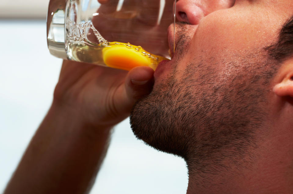 man drinking raw egg