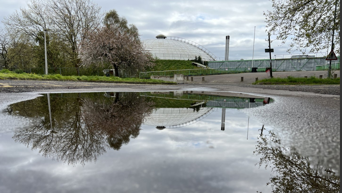 Oasis dome reflected in waterlogged car park