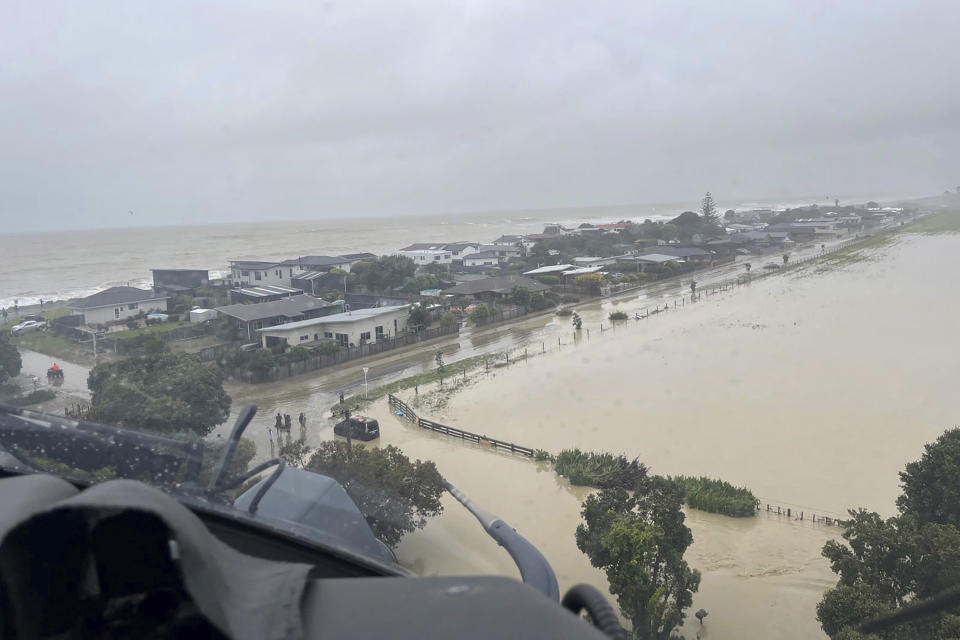 In this image released by the New Zealand Defense Force on Wednesday, Feb. 15, 2023, homes in the Esk Valley, near Napier, New Zealand, are flooded. The New Zealand government declared a national state of emergency Tuesday after Cyclone Gabrielle battered the country's north in what officials described as the nation's most severe weather event in years. (New Zealand Defense Force via AP)