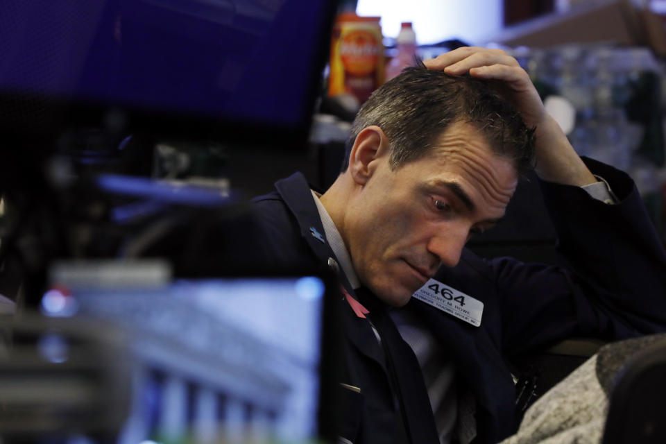 Trader Gregory Rowe prepares for the day's activity on the floor of the New York Stock Exchange, Monday, March 9, 2020. Trading in Wall Street futures has been halted after they fell by more than the daily limit of 5%. (AP Photo/Richard Drew)