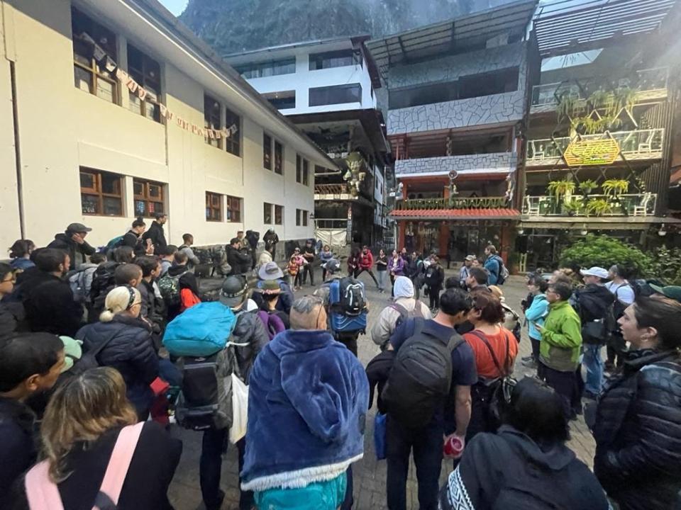 Tourists met in the square of Aguas Calientes, where local authorities gave everyone a briefing for how to travel by foot down the tracks.