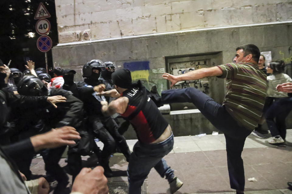 Demonstrators scuffle with riot police during an opposition protest against "the Russian law" near the Parliament building in Tbilisi, Georgia, on Wednesday, May 1, 2024. Clashes erupted between police and opposition demonstrators protesting a new bill intended to track foreign influence that the opposition denounced as Russia-inspired. (AP Photo/Zurab Tsertsvadze)