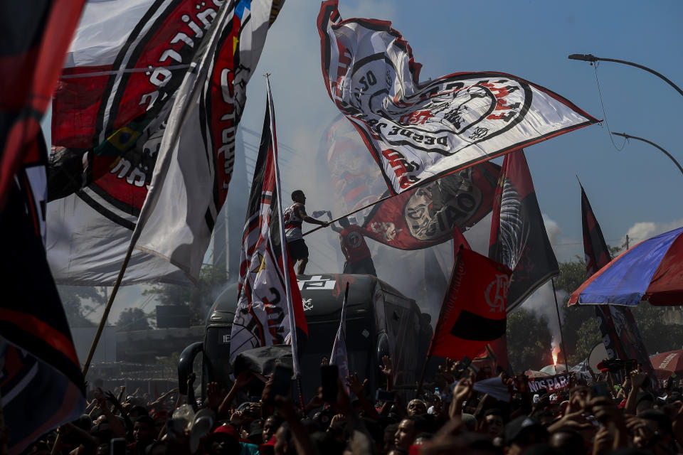 Flamengo soccer fans see their team off as it arrives by bus to the international airport to fly to Ecuador for the Copa Libertadores final, in Rio de Janeiro, Brazil, on Oct. 26, 2022. (AP Photo/Bruna Prado)