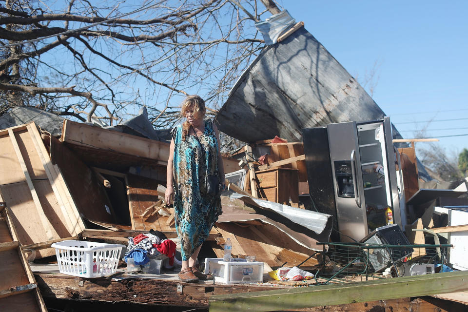 Kathy Coy stands among what is left of her home in Panama City after Hurricane Michael destroyed it. She said she was in the home when it was blown apart and is thankful to be alive.